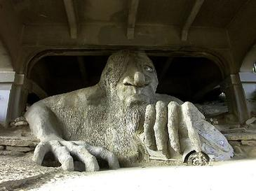 The Fremont Troll, an 18-foot concrete sculpture under Seattle’s Aurora Bridge, clutching a real Volkswagen Beetle in one hand.