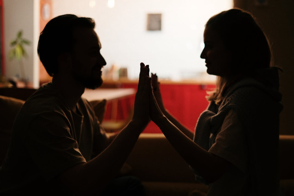 Couple at home touching hands