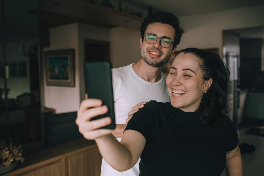 Couple taking smiling selfie